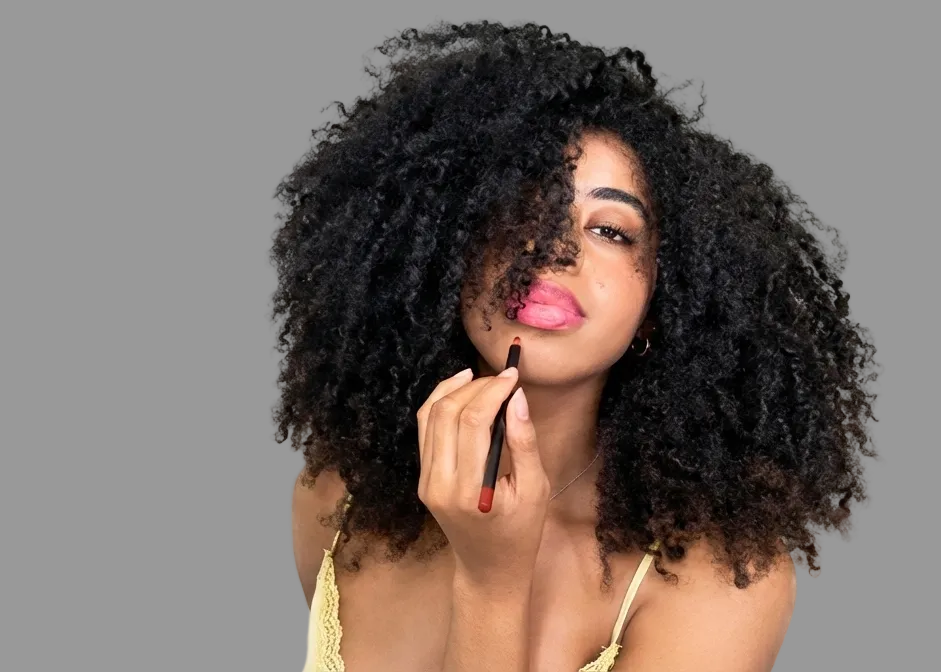 Woman applying lipstick lip liner with a neutral background